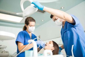 Dentist treating patient with dental tool