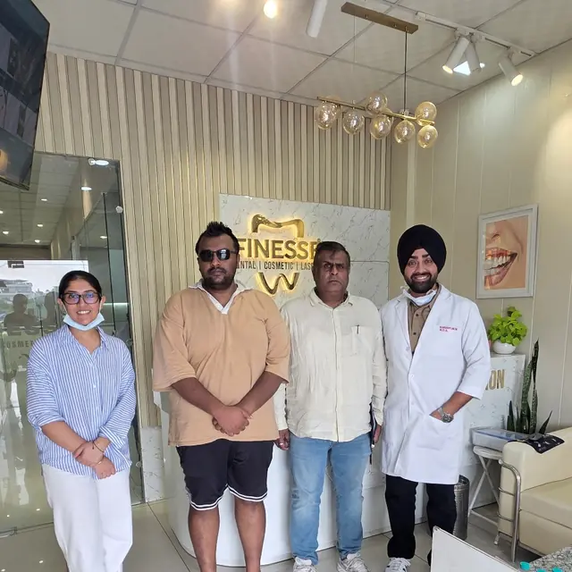 Aryan Garg and his family with the Finesse Dental team after dental implant treatment in Mohali